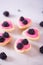 Closeup pink berry yogurt decorated with blackberries in five heart-shaped tartlets
