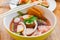 Closeup pink seafood flat noodles Yen ta fo