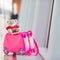 Closeup pink small kids suitcase in airport near