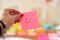 Closeup of pink sticky note with smiley face