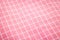 Closeup of pink tablecloth background. Detail of fabric in picnic pattern