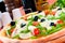 Closeup of a pizza with prosciutto