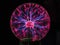 Closeup of a plasma globe in the darkness