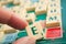 Closeup of plastic letters E in hand on Scrabble board game