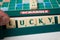 Closeup of plastic letters with word lucky on Scrabble board game