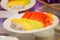 Closeup of a plate of freshly cut fruits on the table under the lights