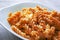 closeup of a plate of fusilli pasta with red tomato sauce