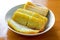 Closeup of a plate of golden Indonesian cakes, Southeast Asian cuisine