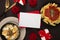 Closeup of a plate of pasta and a bowl of noodles with gifts, roses, and cards