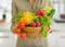 Closeup on plate of vegetables in kitchen in hand of housewife