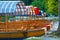 Closeup of pletna boats dock under a lakeside tree on Lake Bled in Slovenia