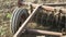 Closeup of plow attached to a tractor plowing a field.