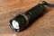 Closeup pocket LED flashlight on dark background