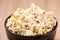 Closeup popcorn in bowl on wood table