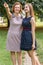 Closeup Portrait of Adult Daughter and Mother Outdoors. Pretty Brunette and Her Mom are Looking at the Camera in the