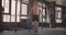 Closeup portrait of adult shirtless muscular caucasian man jumping on the rope in the gym indoors