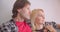 Closeup portrait of affectionate caucasian couple hugging tenderly smiling happily looking at camera sitting on sofa