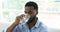 Closeup portrait African man drinks fresh natural water