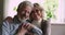 Closeup portrait aged couple embracing smiling looking at camera