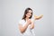 Closeup portrait of attractive caucasian smiling woman brunette pointed on bananas on white background. Healthy food conc