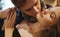 Closeup portrait of beautiful blonde woman with closed eyes, handsome man tenderly kissing his girlfriend