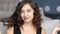 Closeup portrait of beautiful girl in evening dress sitting on floor in luxury interiors