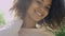 Closeup portrait of a beautiful mixed race woman smiling warmly to a camera.