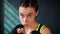 Closeup portrait beautiful young boxing woman training punching in fitness studio