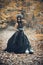 Closeup portrait of Calavera Catrina in black dress. Sugar skull makeup. Dia de los muertos. Day of The Dead. Halloween