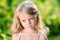 Closeup portrait of capricious blond little girl with pursed lips