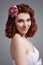 Closeup Portrait of Caucasian Redhaired Girl in White Bridal Dress Posing Against Gray