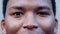 Closeup portrait of a confident black man blinking in slow motion. Young African American male staring blankly ahead