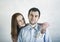 Closeup portrait couple, excited woman, girlfriend pulling money out of man pocket, he looks skeptical, surprised, Shopping lover