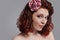 Closeup Portrait of Curious Caucasian Redhaired Girl in White Bridal Dress Posing Against Gray