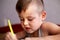 Closeup portrait of cute little boy drawing picture. The beautiful, emotional face of a child of four years