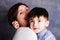 Closeup portrait of cute little boy and woman brunette. Mother and her son hugging