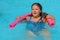 Closeup portrait of cute little girl swimming in the pool, happy child having fun in water summer vacation holidays