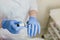 Closeup portrait of doctor s hands in blue gloves working with medicene. Professional cosmetology preparation
