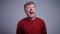 Closeup portrait of excited crazy middle-aged caucasian man happily screaming and looking at camera