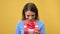 Closeup portrait of excited woman opening festive gift box with red bow rejoicing desired present