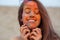 Closeup portrait of expressive brunette model celebrating Holi colors festival at the desert