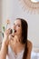 Closeup portrait of a girl eating sponge cake with creamy topping