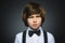 Closeup Portrait of handsome boy with astonished expression while standing against grey background