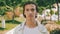 Closeup portrait of handsome confident  young man at the park in summer. Confident teenager looks to the camera, outdoor portrait