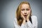 Closeup Portrait of handsome girl with astonished expression while standing against grey background