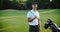 Closeup portrait of handsome young male golfer with golf club.