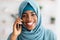 Closeup Portrait Of Happy Black Mulsim Woman In Hijab Talking On Cellphone