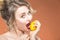 Closeup Portrait of Happy Naked Caucasian Blond Girl Biting Yellow Lemon