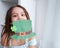 Closeup portrait of a happy preteen caucasian girl in an emerald leprechaun St. Patrick`s Day hat