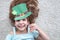 Closeup portrait of a happy preteen caucasian girl in an emerald leprechaun St. Patrick`s Day hat